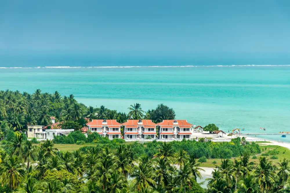 A scenic beachfront resort surrounded by palm trees and turquoise sea—ideal for Maldives tour packages from Bangladesh seeking relaxation and natural beauty