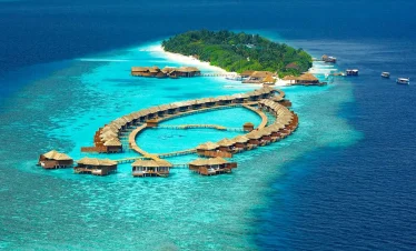 Luxury water villas on a turquoise lagoon in the Maldives, a popular highlight of Maldives tour packages from Bangladesh for honeymooners and luxury travelers