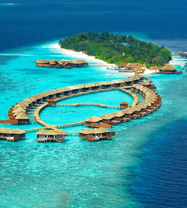 Luxury water villas on a turquoise lagoon in the Maldives, a popular highlight of Maldives tour packages from Bangladesh for honeymooners and luxury travelers