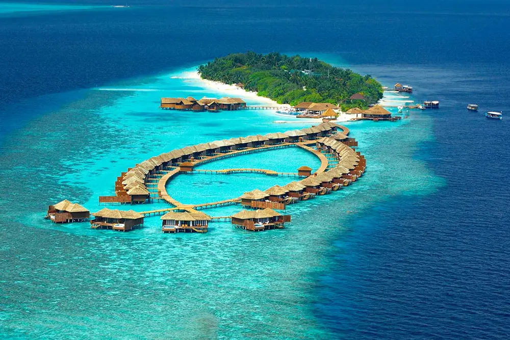 Luxury water villas on a turquoise lagoon in the Maldives, a popular highlight of Maldives tour packages from Bangladesh for honeymooners and luxury travelers