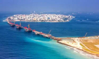 Aerial view of Malé city and connecting bridge, showcasing the urban beauty included in Maldives tour packages from Bangladesh