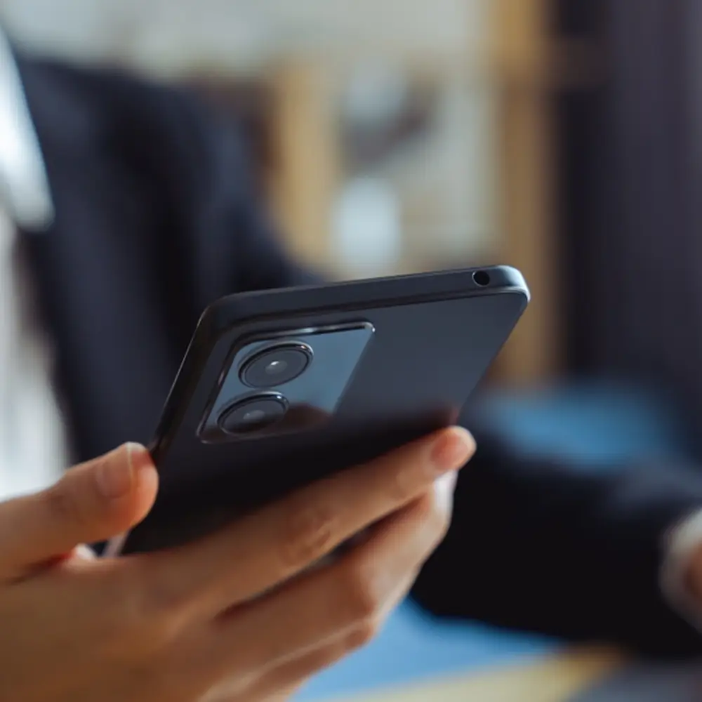 man probably planning malaysia tour packages from bangladesh on smartphone